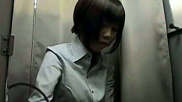 Chinese chick in changing rooms trying on silicone breast pads