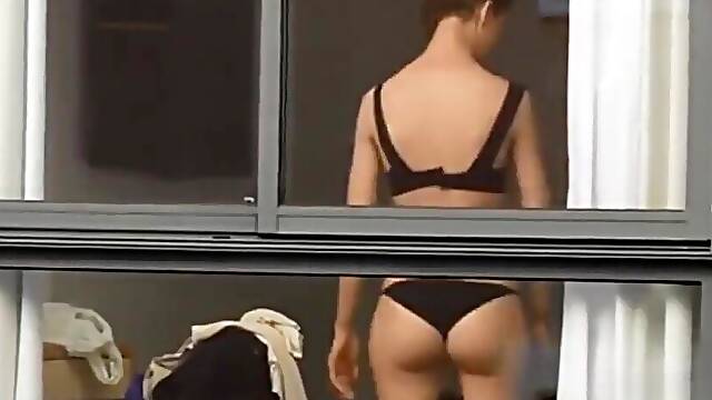 Spying on neighbour undressing.