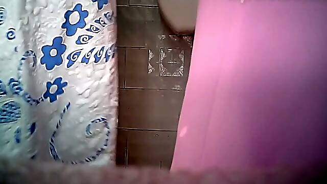 Chunky mature white woman in the toilet room filmed from front