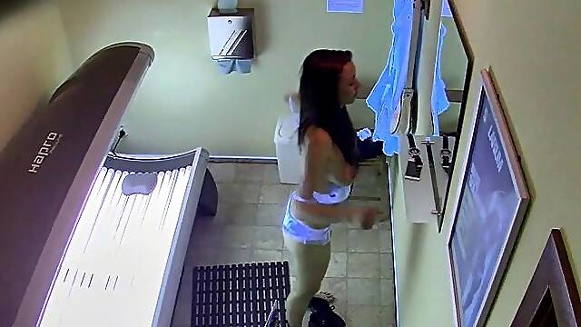 Brunette masturbating in solarium