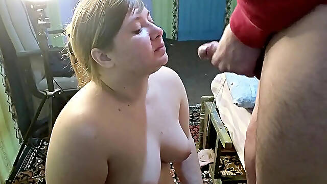 Big-titted mom gives deep blowjob with a smile