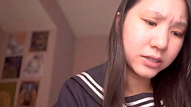 Innocent Japanese schoolgirl reads in her uniform