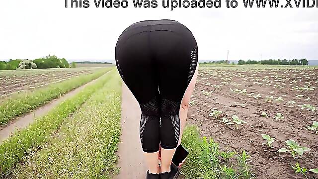 Teasing yoga pants clad babe shows off her perfect phat ass outdoors
