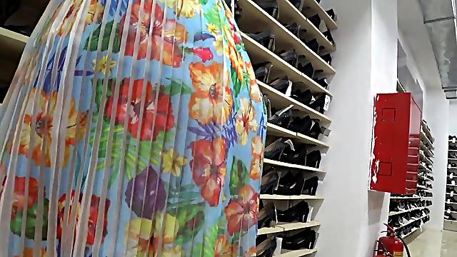 Voyeur spying hot legs and large butt below the petticoat in a public shoe store.