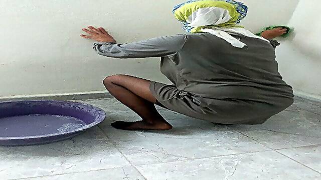 Hijab woman cleaning kitchen