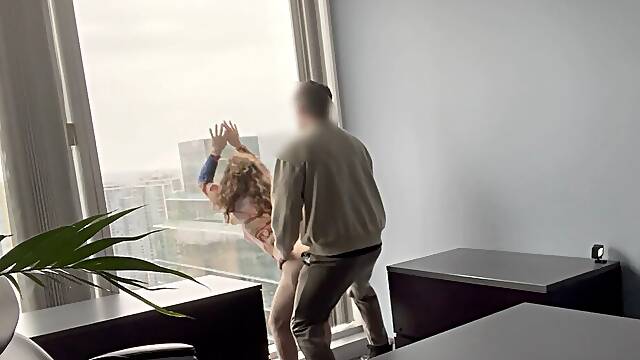 MILF boss fucked against her office window