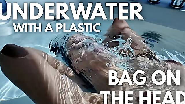 UNDERWATER WITH A PLASTIC BAG ON HEAD
