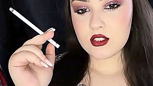 Smoking slim cigarettes with red lips