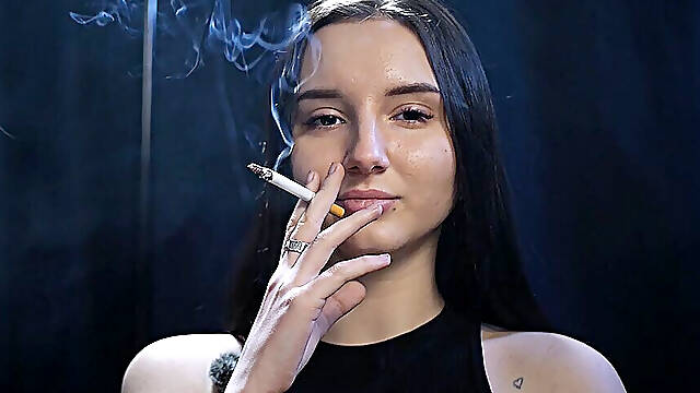 Elegant Brunette Smoking in Black Outfit